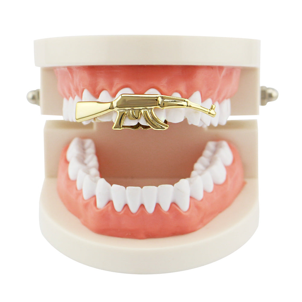 Hillenic "AK 47" 2 teeth Gold Grillz, on the teeth gold grillz, Hillenic Grillz, machine gun gold grillz